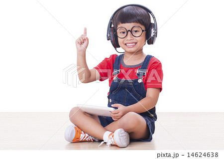 Happy boy with headphones connected to a tablet Happy boy with headphones connected to a tablet 14624638
