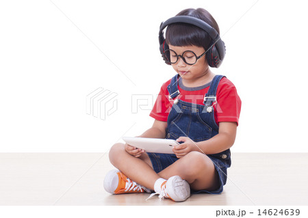 Happy boy with headphones connected to a tablet  14624639