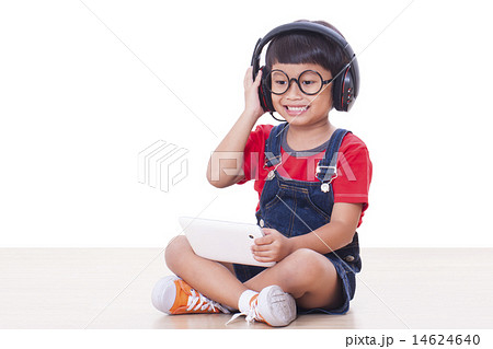 Happy boy with headphones connected to a tablet  14624640