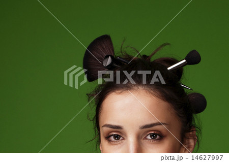 Beautiful woman with makeup brushes - Stock Image 14627997
