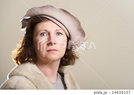 Serious brunette in taupe hat and fur 14639157