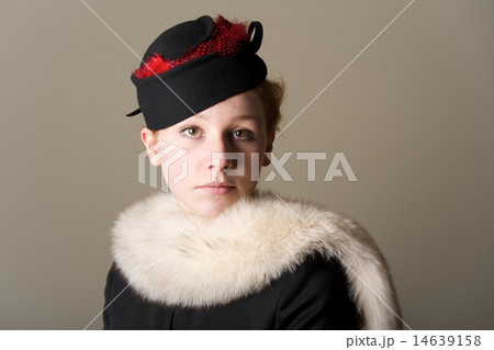 Serious redhead in black hat and fur 14639158