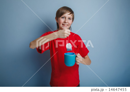 boy teenager European appearance in a red shirt brown drops tea  14647455