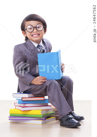 Cute boy in suit reading a book 14647562