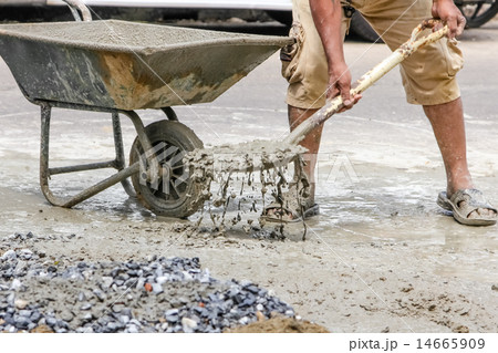 construction workers mixing cement construction workers mixing cement 14665909