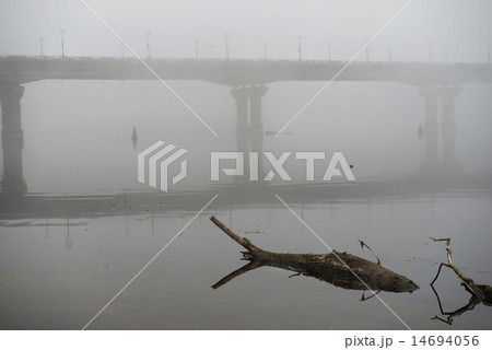 Bridge through river in misty morning 14694056
