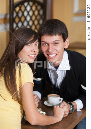 Happy couple smiling on coffee table. 14695129