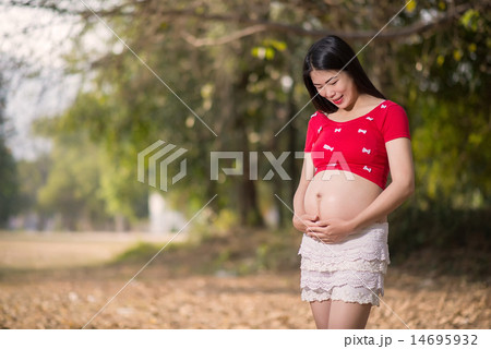 Image of pregnant woman touching her belly with hands Image of pregnant woman touching her belly with hands 14695932