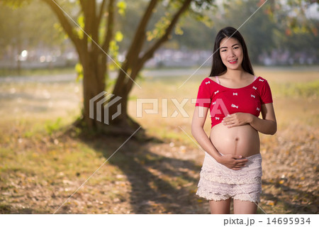 Image of pregnant woman touching her belly with hands Image of pregnant woman touching her belly with hands 14695934