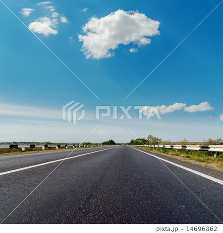 asphalt road to horizon under blue cloudy sky asphalt road to horizon under blue cloudy sky 14696862