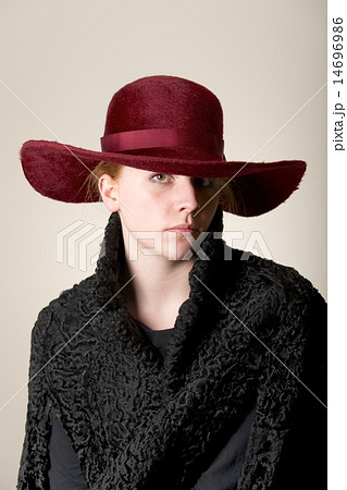 Redhead serious in maroon hat and black coat Redhead serious in maroon hat and black coat 14696986