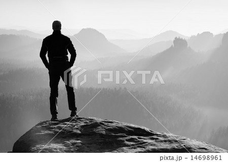 Hiker is standing on the peak of sandstone rock Hiker is standing on the peak of sandstone rock 14698961
