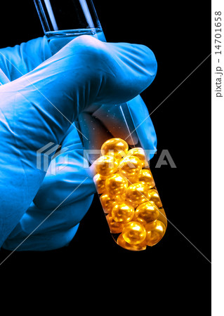 Hand holding tube with white pearls Hand holding tube with white pearls 14701658