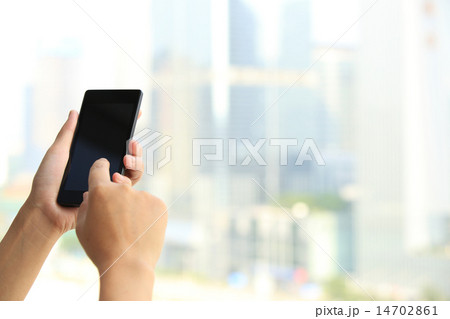 woman hands use smart phone in modern city 14702861