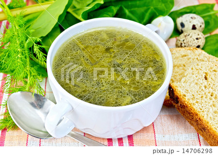 Soup of greenery with bread on cloth 14706298