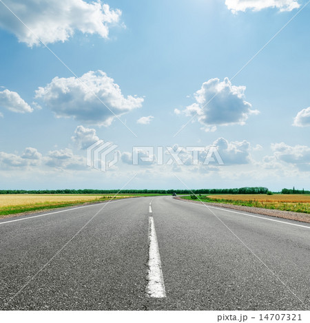 asphalt road with white line to cloudy horizon 14707321