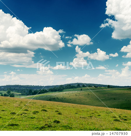 green hills and deep blue sky with low clouds green hills and deep blue sky with low clouds 14707930