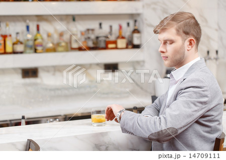 Young man sits at the counter of bar Young man sits at the counter of bar 14709111