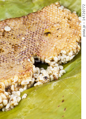 roasted immature beehive on banana leaves 14720772
