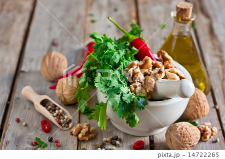 Cilantro and walnuts in a mortar Cilantro and walnuts in a mortar 14722265