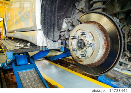Close up of disk brake on car in process Close up of disk brake on car in process 14723445