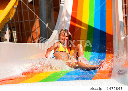 Child in bikini sliding water park. 14728434