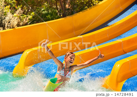 Child in bikini sliding water park. 14728491