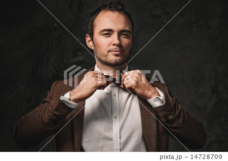 Cheerful sharp dressed fashionist wearing jacket and bow tie Cheerful sharp dressed fashionist wearing jacket and bow tie 14728709