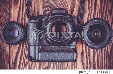 camera and lenses on wooden desk background. camera and lenses on wooden desk background. 14733501