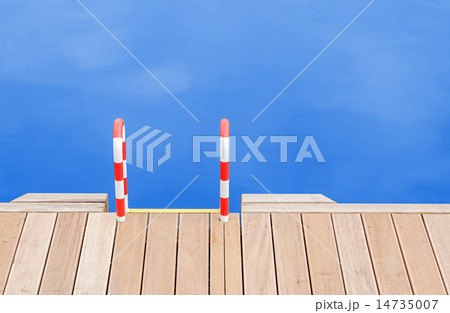 Wooden pier and ladder by the blue water. 14735007