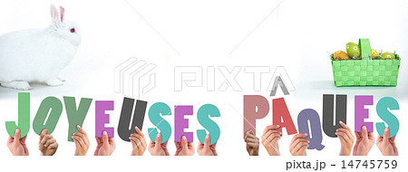 Composite image of hands holding up joyeuses pasques 14745759