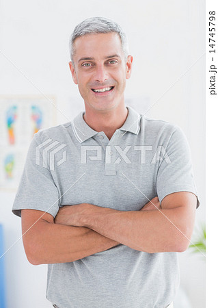 Smiling doctor standing arms crossed and looking at camera 14745798