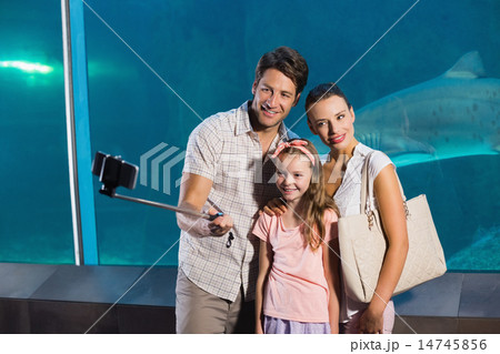 Happy family using selfie stick Happy family using selfie stick 14745856