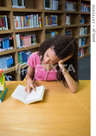 Pretty student studying in the library Pretty student studying in the library 14745930