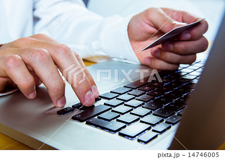 Man using laptop for online shopping 14746005