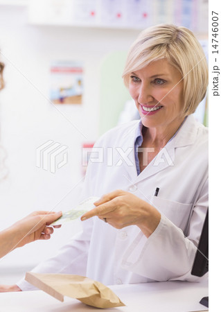 Pharmacist taking money 14746007