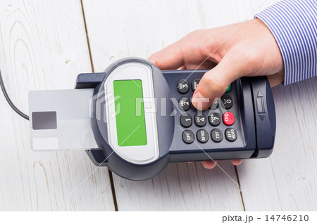 Man entering his pin on terminal Man entering his pin on terminal 14746210