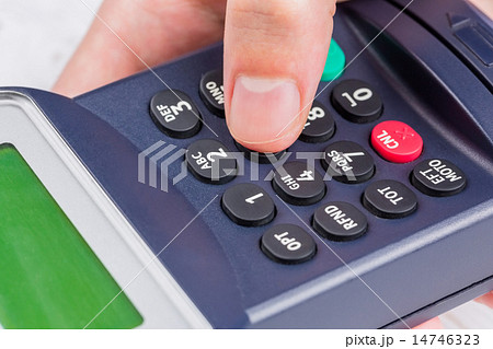 Man entering his pin on terminal Man entering his pin on terminal 14746323