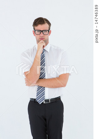 Serious geeky businessman thinking and holding his chin 14746389