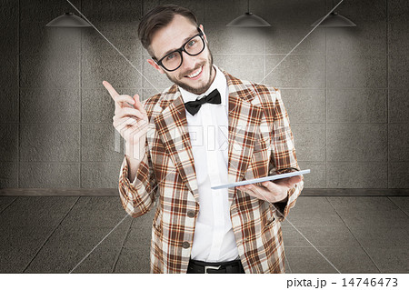 Composite image of geeky hipster holding a tablet pc 14746473