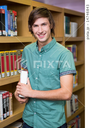 Student smiling at camera in library 14746843