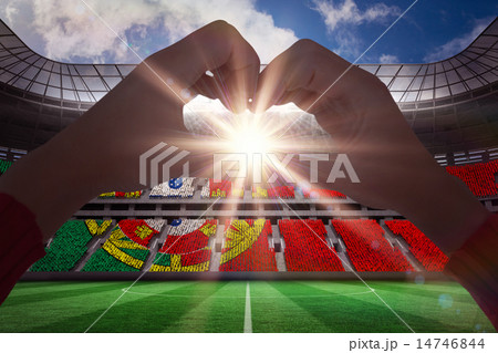 Composite image of woman making heart shape with hands 14746844