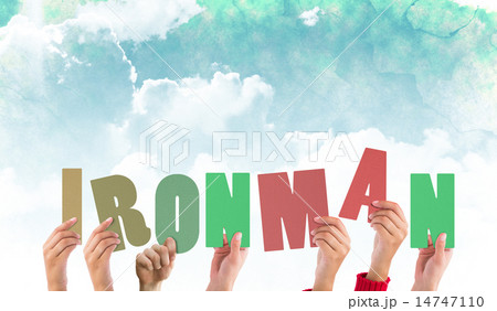 Composite image of hands holding up ironman 14747110