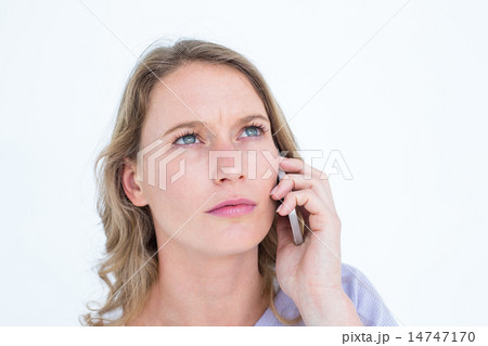 Unsmiling woman calling with her smartphone 14747170