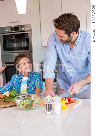 Happy family preparing vegetables together Happy family preparing vegetables together 14747409