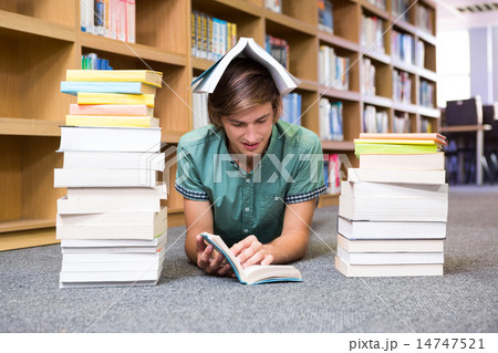 Student lying on library floor Student lying on library floor 14747521