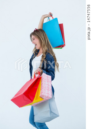 Excited woman holding some shopping bags Excited woman holding some shopping bags 14747556