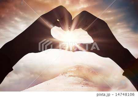 Composite image of woman making heart shape with hands 14748106