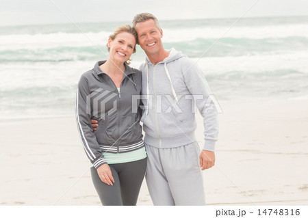 Fit couple smiling at camera Fit couple smiling at camera 14748316