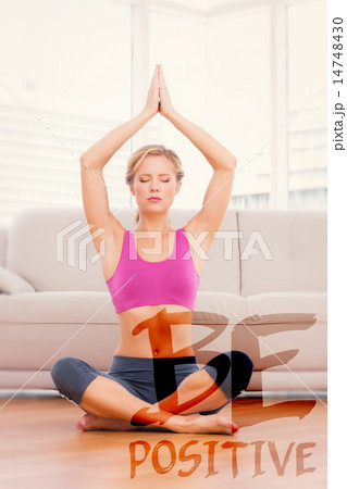 Composite image of calm blonde meditating in lotus pose with arm Composite image of calm blonde meditating in lotus pose with arm 14748430